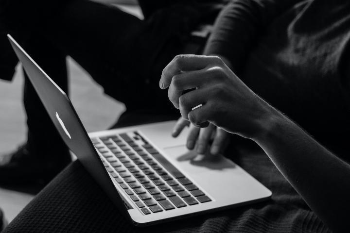 A person is working with a laptop with high efficiency and productivity.